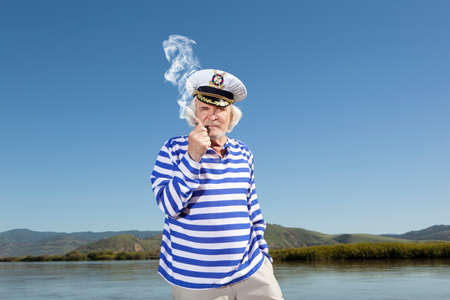 Captain smokes a pipe. Sailor manの写真素材