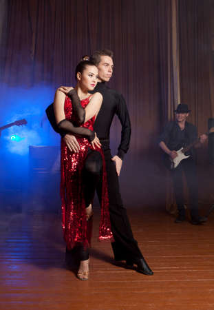 Dance beautiful couple dancing ballroom dancing on dark backgroundの写真素材