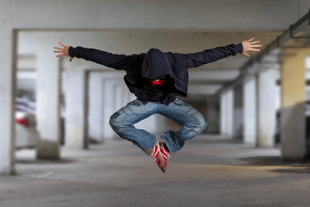 Levitation. Young man break dancing on wall background