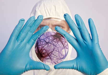Scientist holding a petri dish with virus cells. Virus conceptの写真素材