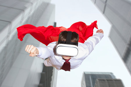Businessman superhero wearing virtual reality glasses flying above a city