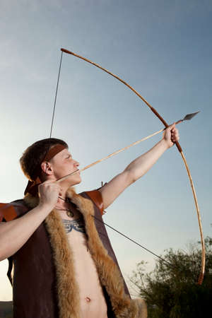 Robin Hood. Young archer in vintage clothes with arrow and long bowの写真素材