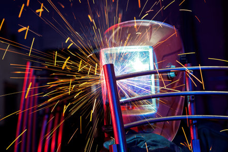 Welder erecting technical steel. Industrial steel welder in factory technical
