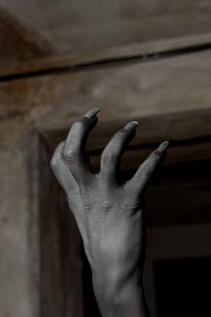 Black hands of the devil on wall background. Horror conceptの写真素材