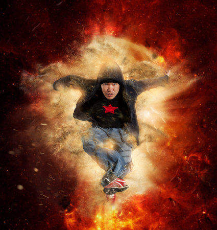 Young man break dancing on gold background