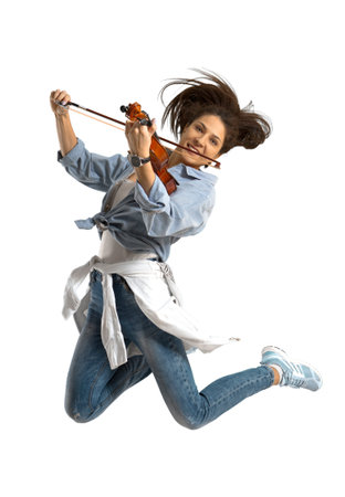 Playing the violin. Young woman playing violin on white isolated background の写真素材