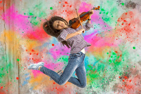 Woman playing violin on on splash backgroundの写真素材