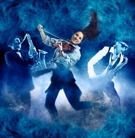 Woman playing violin on on smoke backgroundの写真素材