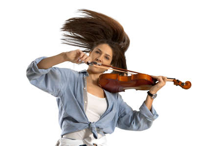 Playing the violin. Young woman playing violin on white isolated background の写真素材