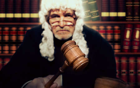 Judge. Male judge in a courtroom striking the gavelの写真素材