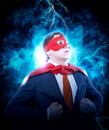 Businessman showing the super man suit under his shirt on electricity light backgroundの写真素材