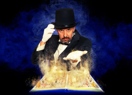 Magician and magic book on electricity light backgroundの写真素材