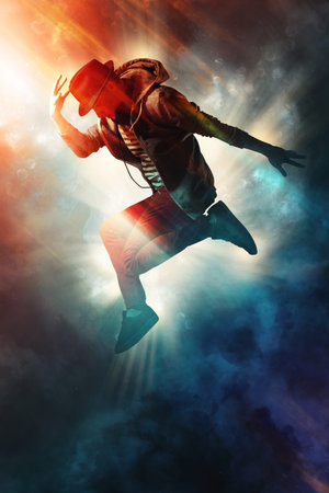 Young man break dancing on smoke backgroundの写真素材