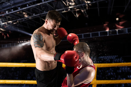 Two professional boxer boxing on black background