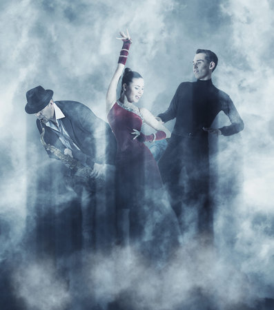 Pair of dancers dancing ballroom. Smoke background. Soft focus image