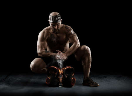 Muscular man clapping hands and preparing for workout at a gymの写真素材