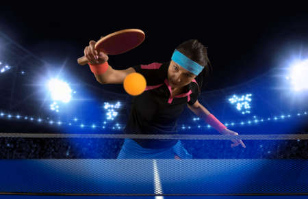 Portrait woman playing ping pong on darkの写真素材
