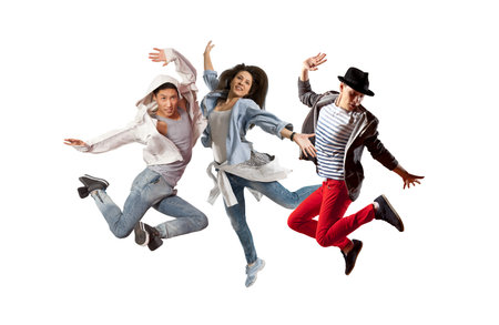 Beautiful young trio in dance studio. Sporty hip-hop dancers