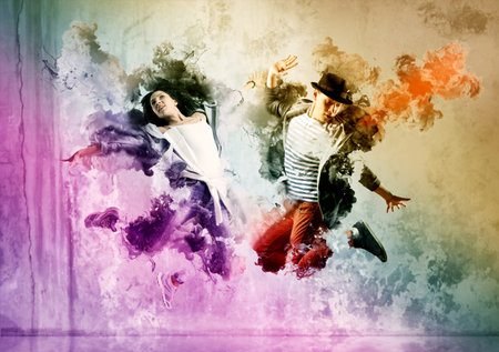 Beautiful young couple in dance studio. Sporty hip-hop dancers