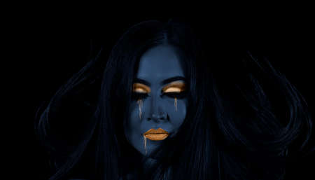 High fashion model woman. Art blue, gold skin girl face portrait closeup. Glamour professional makeupの写真素材