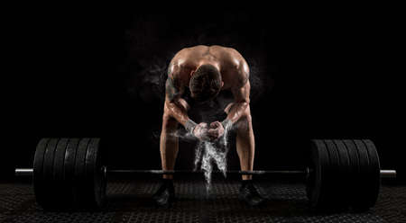 Muscular man workout with barbell at gym. Sports banner. Horizontal copy space backgroundの写真素材