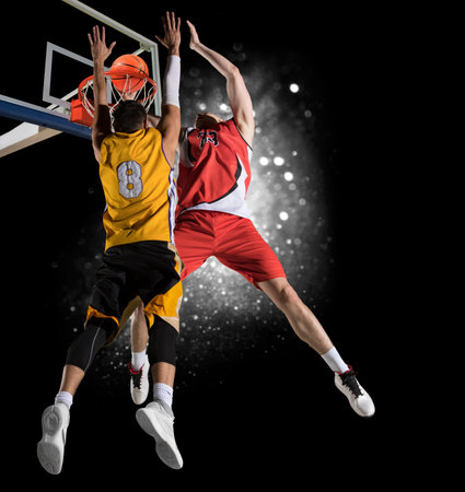 Two basketball players in action in gym
