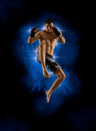 Martial arts fighter (MMA) jumping with a knee kick. Smoke background