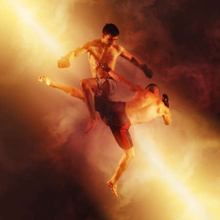 MMA boxers fighters fight in fights without rules on red smoke backgroundの写真素材