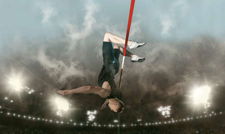 Man in action of high jump on sky background. Sports banner. Horizontal copy space backgroundの写真素材