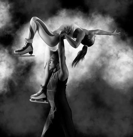 Lift. Duo figure skating in action on black background. Sports bannerの写真素材