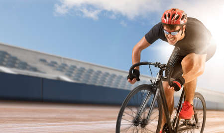 Man racing cyclist in motion on track background. Concept of sport, movement, energy, dynamic, healthy lifestyleの写真素材