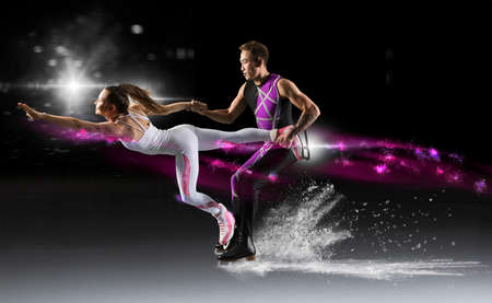 Duo figure skating in action on black backgroundの写真素材