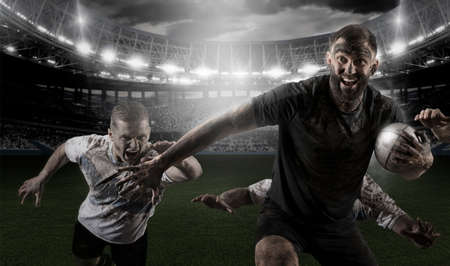 Rugby football player in action on dark arena backgroundの写真素材