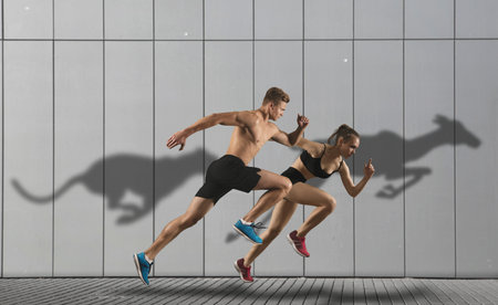 Strong athletic man and woman running on wall background wearing in sportswear. Sport and fitness...