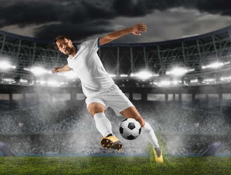 Soccer player in action on stadium backgroundの写真素材