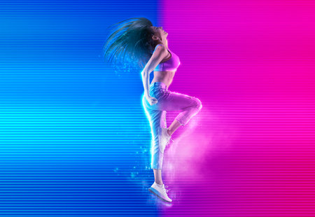 Woman jumping on neon background. Fitness model in jeans on neon background. dance bannerの写真素材