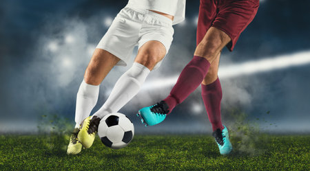 Two football player man in action on dark arena backgroundの写真素材