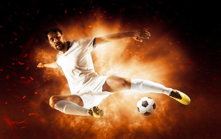 Soccer player in action on fire backgroundの写真素材