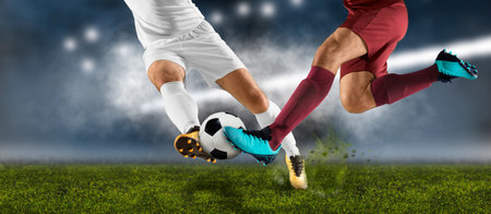 Two football player man in action on dark arena backgroundの写真素材