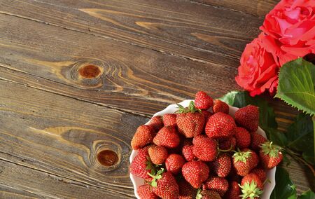 ripe, fragrant strawberries on a table made of woodの写真素材