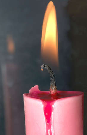 Close-up of a burning, pink candle.の写真素材