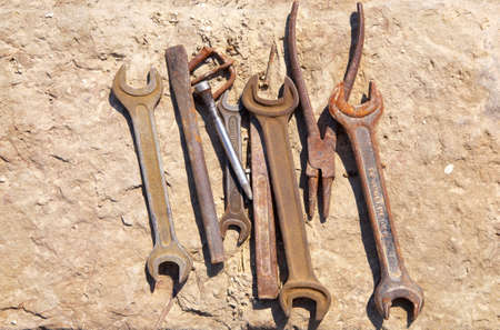 Assorted old tools on concrete block.の写真素材
