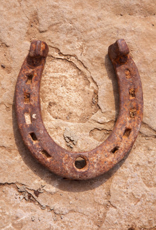 Antique horseshoe on concrete block background.の写真素材