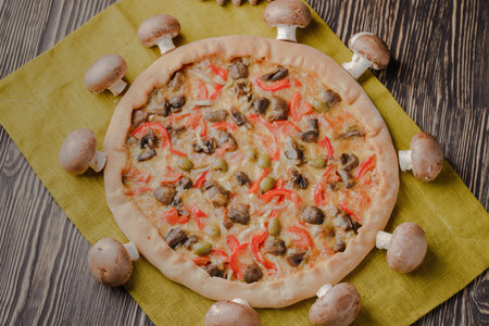 Pizza with mushrooms and with homemade cheese on a wooden tableの写真素材