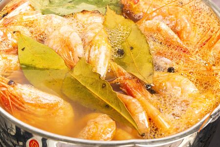 Atlantic prawns are cooked with Bay leaf and allspice in a stainless steel pan.の写真素材