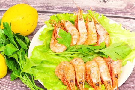 Cooked Atlantic prawns served with parsley and lemon salad.の写真素材
