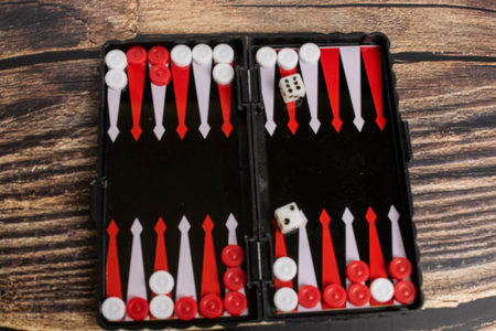 Small pocket backgammon on a wooden table.