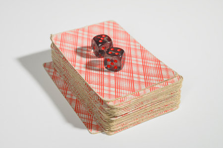 Dice and playing cards on white background. Not isolate.