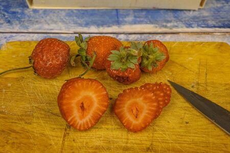 Strawberries with leaves. on a wooden table. Juice strawberryの写真素材