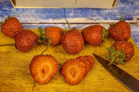 Strawberries with leaves. on a wooden table. Juice strawberryの写真素材